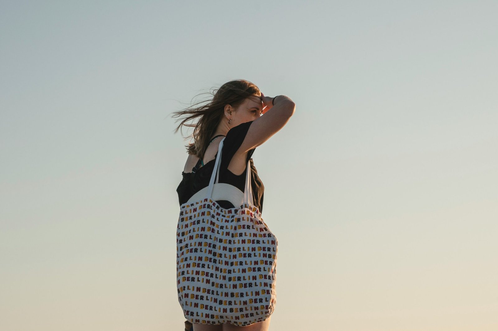 woman carrying white bag during daytime