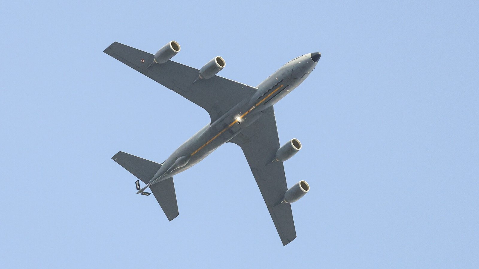 A large jetliner flying through a blue sky