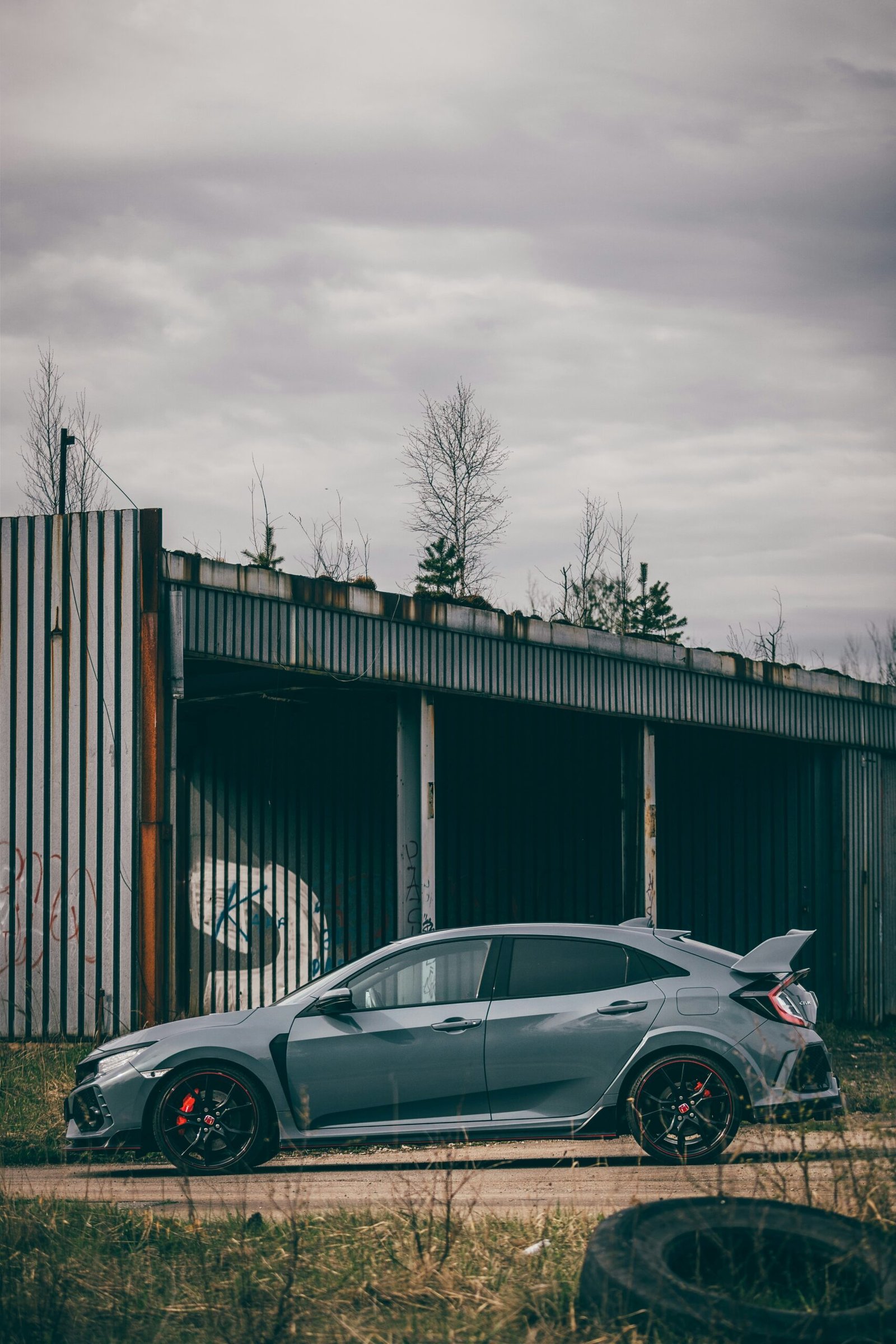 a grey car parked in front of a building